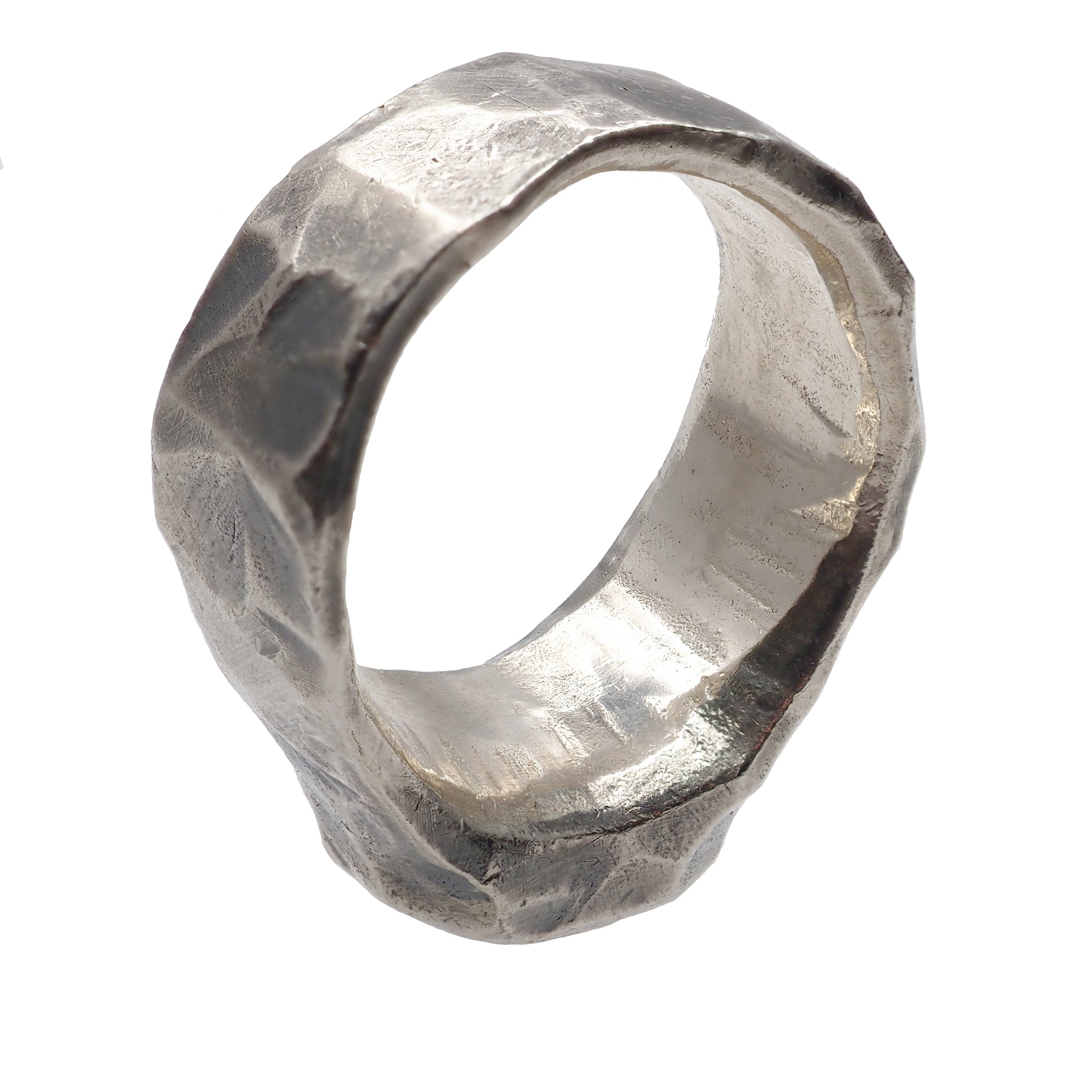 silver ring is on the front of edge on white backround