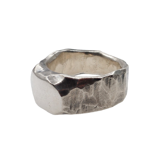 silver textured ring on white background